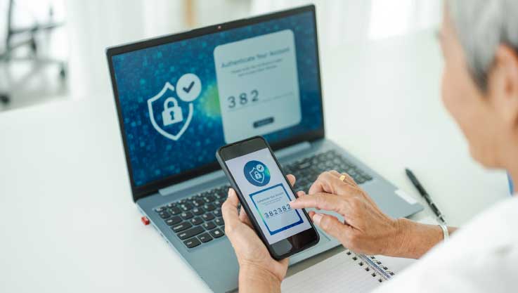 A person completes two-step authorization using their phone and laptop with a special code. 